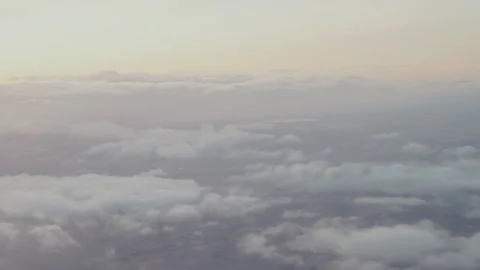 Scattered clouds over the plains seen from a plane Stock Footage 347983082