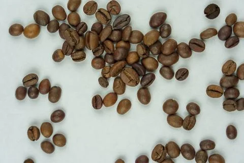 Scattered coffee beans on light background Stock Photos