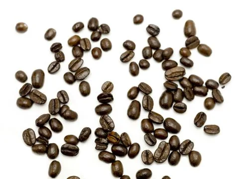 Scattered Coffee Beans on White Stock-Fotos