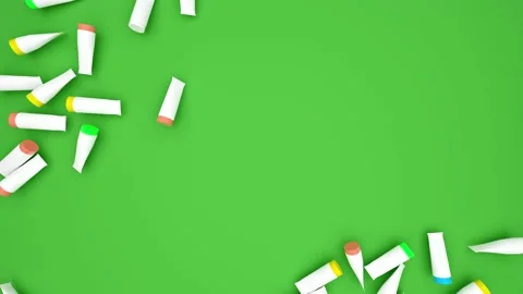 Scattered Colorful Plastic Tubes on Green surface wiped to create space for text Stock Footage 201140236