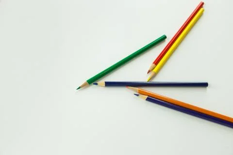 Scattered coloring artist pencils on solid background Stock Photos