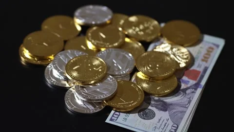 Scattered Crypto Coins on Spread 100 US Dollar Bills Stock Footage 318810069
