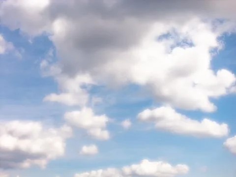 Scattered Cumulus Clouds Across a Broad Blue Sky Stock Photos