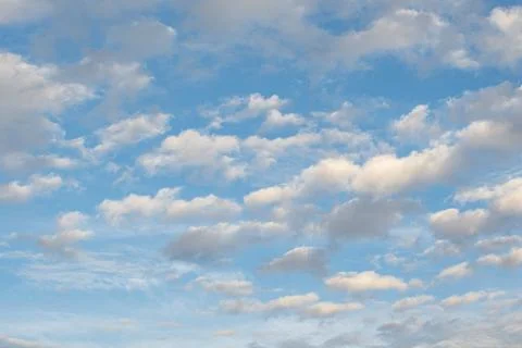 Scattered Cumulus Clouds Float Across Bright Blue Afternoon Sky Stock Photos