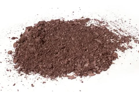 Scattered dark brown eye shadow isolated on a white background Stock Photos