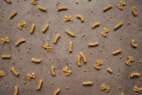 Scattered Different Types of Pasta on the Table Stock Photos