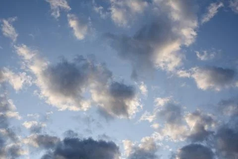 Scattered Evening Clouds in Blue Sky at Dusk Stock Photos