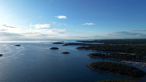 Scattered forested islets dot calm Adriatic waters, marina harbor and boats Stock Footage 338047733