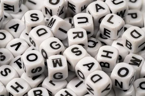 Scattered letter blocks in various orientations on a flat surface Stock Photos