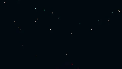 Scattered multi-colored micro LED lights shimmering subtly across a vast pitch-b Stock Footage 345971856