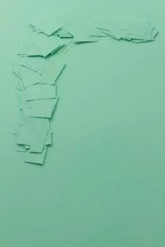 Scattered paper scrap on the same colour surface with copy space Stock Photos