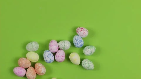 Scattered pastel eggs on green backgroound. Happy Easter holiday concept Stock Footage