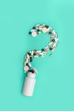 Scattered pills in the shape of a question mark Uncertainty from Stock Photos