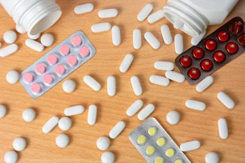Scattered pills on the table Stock Photos