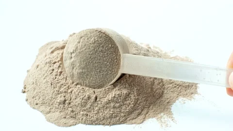 Scattered protein and measuring spoon on white background top view, concert of Stock Footage 236356713