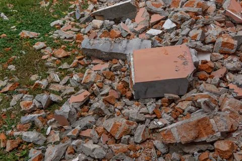 Scattered rubble consisting of broken concrete and reddish-brown bricks Stock Photos