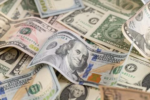 Scattered US Dollar Banknotes Background with Focus on Hundred Dollar Bill Stock Photos