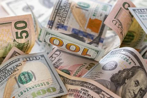 Scattered US Dollar Banknotes Background with Focus on Hundred Dollar Bill Stock Photos