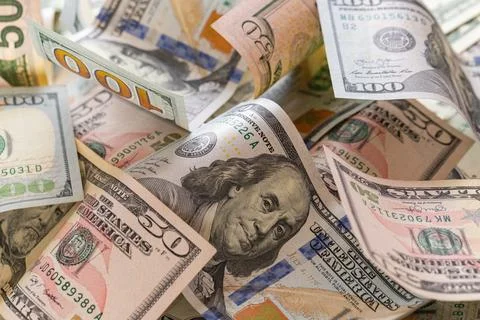Scattered US Dollar Banknotes Background with Focus on Hundred Dollar Bill Stock Photos