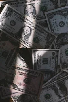 Scattered US dollars on a table. Stock Photos