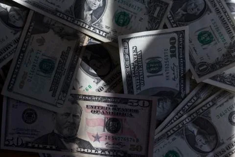 Scattered US dollars on a table. Stock Photos