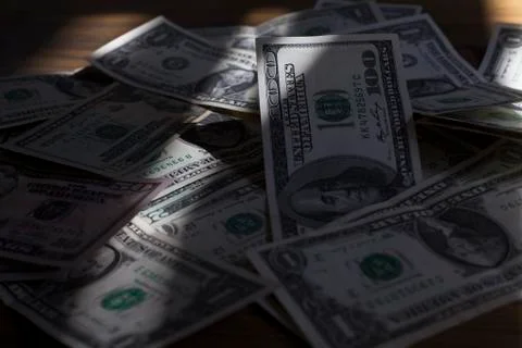 Scattered US dollars on a table. Stock Photos