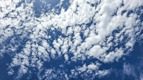 Scattered White Altocumulus Cloudscape over Deep Blue Sky Stock Photos