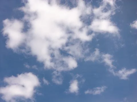 Scattered White Cloud Patches in a Deep Blue Daytime Sky Stock Photos