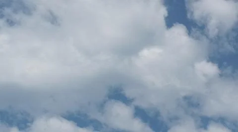 Scattered white clouds against a bright blue sky Stock Photos