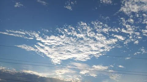 Scattered White Clouds and Blue Sky Background Fotos de archivo