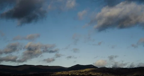 Scattered Wispy Cloud Blue Sky Timelapse Over Mountains 4K Stock Footage 113930125