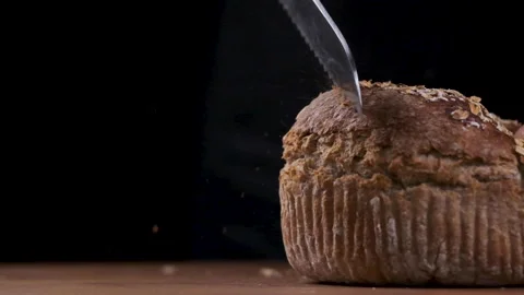 Scattering  bread crumbs  while cutting bread slow motion Stock Footage 169238626