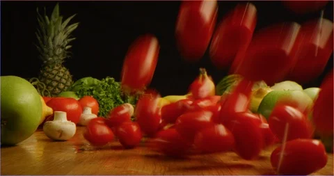 Scattering cherry tomatoes on table with composition of fruits and vegetable Video stock 126301572