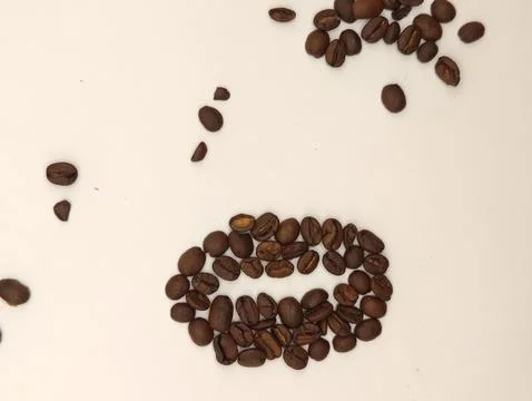 A scattering of coffee beans on a light background Stock Photos