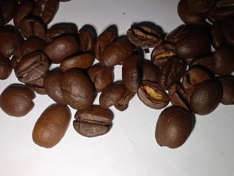 A scattering of coffee beans on a white background Stock Photos