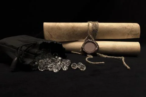 A scattering of diamonds and old scrolls with a seal. Stock Photos