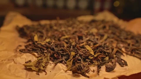 A scattering of dried tea lying on brown parchment. Stock-Footage 264393868