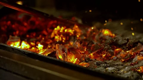 Scattering embers in the fireplace Stock Footage 327604000