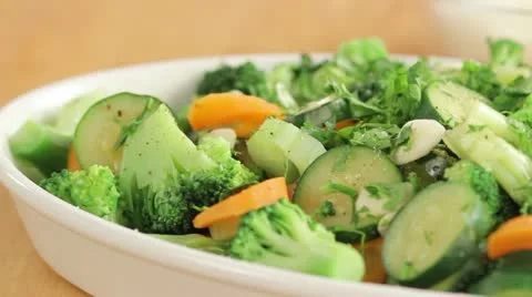 Scattering freshly grated parmesan over vegetables Video stock 24664751
