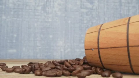 A scattering of freshly roasted coffee beans has spilled out from a charming 스톡 동영상 288970038