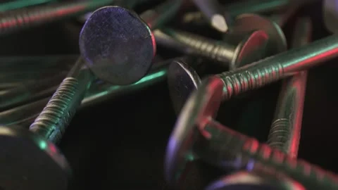 A scattering of galvanized screw nails on a dark surface. The concept of use for Stock Footage 159499103