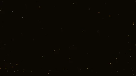 A scattering of glowing golden embers floating against a dark black backdrop 库存影片 338310580