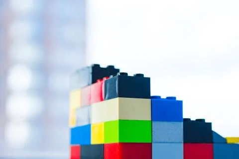 A scattering of many colored blocks from the designer. a house made of colored Stock Photos
