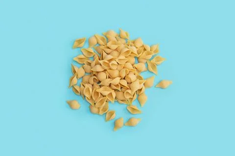A scattering of pasta on a blue background Stock Photos