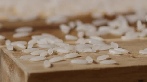 Scattering rice on kitchen table macro shot Stock-Footage 128493690