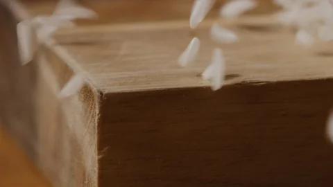 Scattering rice on kitchen table macro shot Stock Footage 128493734