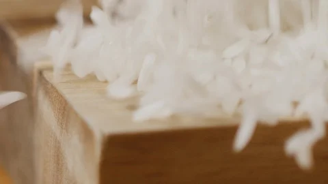 Scattering rice on kitchen table macro shot Stock Footage 128493861
