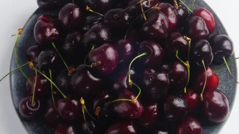 Scattering of ripe dark red cherries rotating in a circle. Medium plan 库存影片 296651961