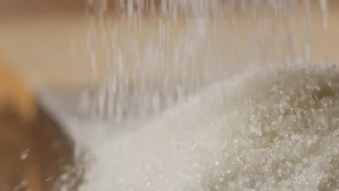 Scattering sugar on kitchen table macro shot Stock-Footage 128493649