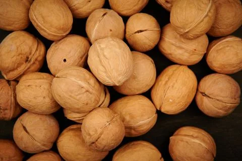 A scattering of walnuts on a dark background Stock Photos